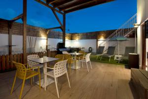 a patio with tables and chairs at night at Casa Miranda in Candelaria