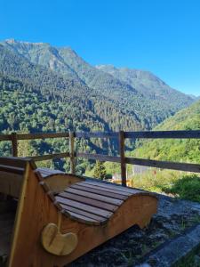 a wooden bench sitting on top of a mountain at Foresteria Giardino in Paisco +2 photos