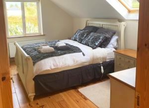 a bedroom with a bed with two teddy bears on it at Valentia View Holiday Home in Cahersiveen