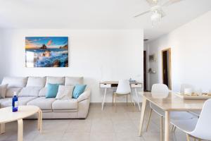 a living room with a couch and a table at Home2Book Comfy Seaside Apartment Cristimar, Pool in Los Cristianos
