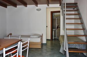 a room with a bunk bed and a staircase at Palazzo De Donno in Santa Cesarea Terme