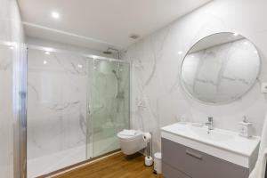 a bathroom with a shower and a sink and a toilet at Pestana Apartments - Premium in Porto