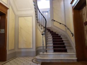 a staircase in a building with a stair case at Modern Design One Bedroom Apartment in Paris