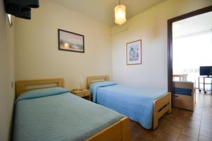 En eller flere senge i et værelse på Appartamenti Oasi + 16 billeder