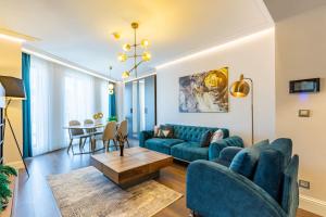a living room with a blue couch and a table at Stylish Flat near Trendy Attractions in Beyoglu in Istanbul