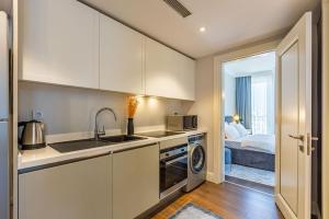 a kitchen with a sink and a washer and dryer at Stylish Flat near Trendy Attractions in Beyoglu in Istanbul