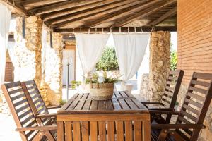 a wooden table with a basket of flowers on a patio at Dammusi Ziunì in Lampedusa