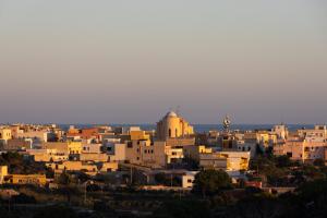 a cityscape of a city at sunset at Dammusi Ziunì in Lampedusa