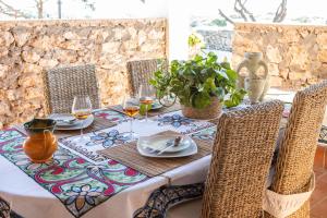 a table with chairs and a table cloth on a table at Dammusi Ziunì in Lampedusa