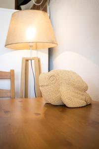 a stuffed animal sitting on a table next to a lamp at Dammusi Ziunì in Lampedusa