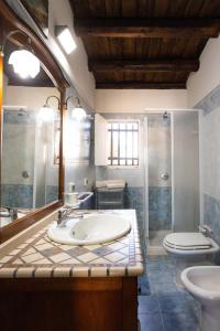 a bathroom with a sink and a toilet at Dammusi Ziunì in Lampedusa