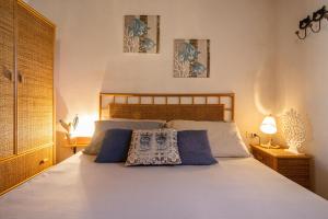 a bedroom with a bed with two pillows on it at Dammusi Ziunì in Lampedusa