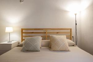 a bedroom with a large bed with two pillows at Dammusi Ziunì in Lampedusa