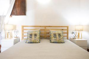 a bedroom with a large bed with two night stands at Dammusi Ziunì in Lampedusa