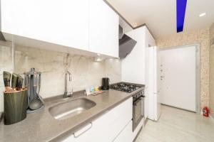 a kitchen with a sink and a stove at Modern Flat near Beach in Antalya in Antalya