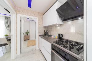 a kitchen with a stove and a counter top at Modern Flat near Beach in Antalya in Antalya