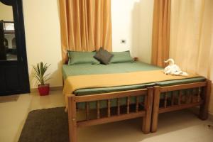 a bed with a dog sitting on top of it at RED LION in Varkala