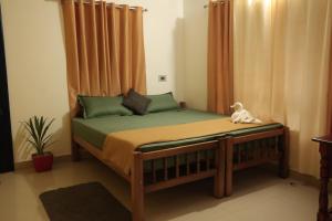 a bedroom with a bed with a canopy at RED LION in Varkala