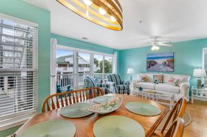 a living room with a table and chairs and a couch at South Beach Views in Tybee Island
