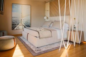 a bedroom with a swinging bed with a painting on the wall at Miramare Suites in Sestri Levante