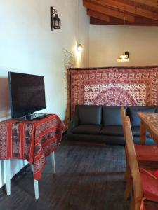 a living room with a couch and a table at NECOCHEA DEPARTAMENTO TIPO LOFT 4 PAX in Necochea +4 photos