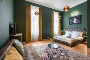 a bedroom with green walls and a bed and a table at The Pearl of the Heart of Budapest in Budapest