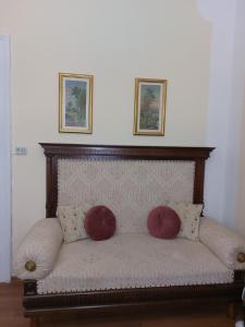 a couch with two pillows on top of it at Apartman Dane in Kikinda