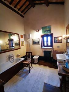 a bathroom with a tub and a toilet and a sink at Casale Druida in Poggio Mirteto