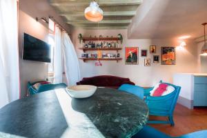 a dining room with a black table and blue chairs at Easylife - Splendido appartamento con vista sul Naviglio Grande in Milan