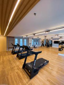 a gym with several treadmills in a room at Fortaleza Sul Flats Service in Fortaleza