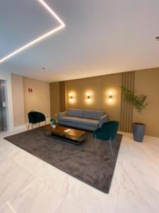 a living room with a couch and two chairs at Fortaleza Sul Flats Service in Fortaleza