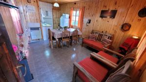 a kitchen and dining room with a table and chairs at Cabañas de Montaña Tecta-Cher in Potrerillos