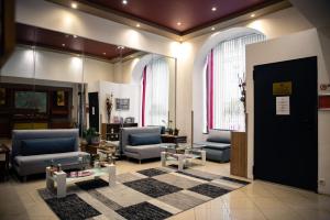 a lobby with couches and tables in a building at Hotel Resonanz Vienna in Vienna