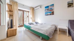Łóżko lub łóżka w pokoju w obiekcie Apartamenty Sun & Snow Lido Sarbinowo