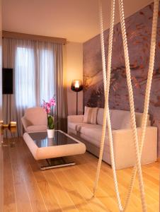 a living room with a couch and a swing at Miramare Suites in Sestri Levante