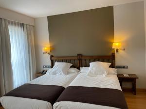Łóżko lub łóżka w pokoju w obiekcie Parador de Puebla de Sanabria