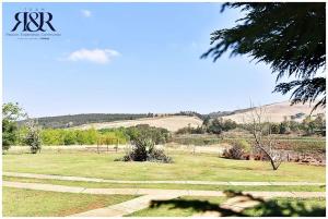 a field of grass with a park with a playground at The Falls Cottages in Balgowan