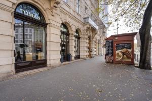 an empty street in front of a building at The Pearl of the Heart of Budapest in Budapest