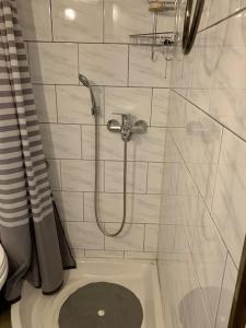 a white bathroom with a shower and a toilet at Beautiful apartment Athens Keramikos in Athens