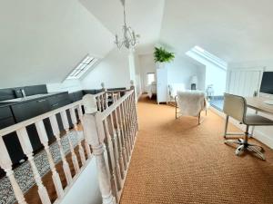 a living room with a staircase and a bedroom at West Hill Retreat Seaview Balconette Loft Apartment with Free Parking in Hastings