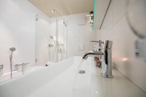 La salle de bains est pourvue d'un lavabo et d'un robinet. dans l'établissement Apartment Caspar, à Riederalp