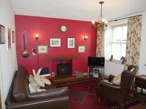 a living room with a couch and a fireplace at Middle Cottage in Leyburn