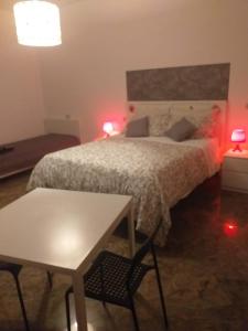 a bedroom with a bed and a table and two lamps at Executive center rooms in Bari