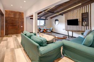 a living room with two blue couches and a television at Casa Miranda in Candelaria