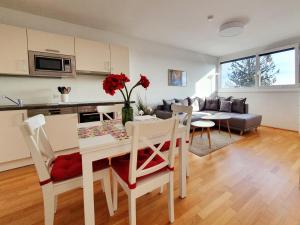 a kitchen and living room with a table and chairs at Near Lake Stylish & Fully Furnished Apartment in Vienna