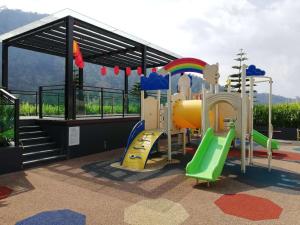a playground with a slide and slides at Cozy 2 Bedroom Suite Vista Genting FREE WIFI in Genting Highlands
