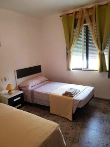 a bedroom with two beds and a window at House near beach in Peñíscola for 4 in Peñíscola