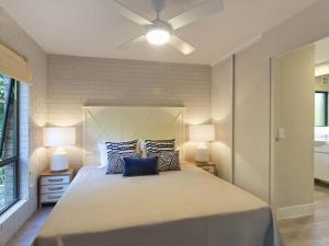 a bedroom with a large bed with two lamps at Sundown Lodge 2 Edgar Bennett Avenue 14 in Noosa Heads +11 photos
