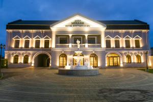 a large building with a fountain in front of it at Muller Hotel Boutique & Spa in Galaţi