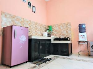 a kitchen with a purple refrigerator in a room at MG Villa in Tlekung